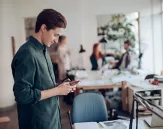 Man checking phone at the office