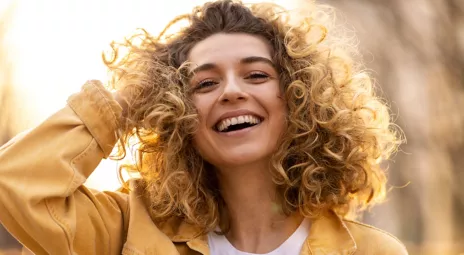 Young smiling woman with curly hair