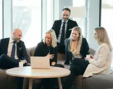 A consultant sitting on a sofa laughing